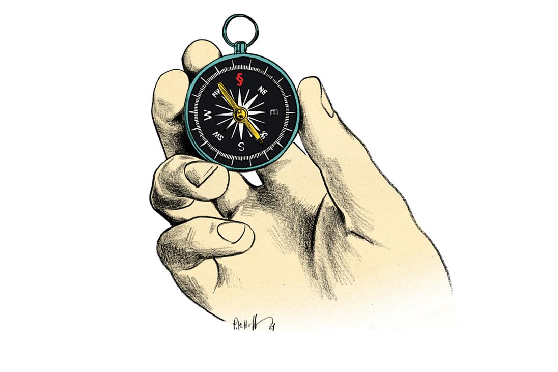 Hand, die einen Kompass hält
