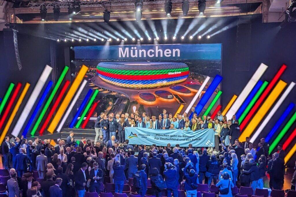 Gruppe von Menschen freut sich &uuml;ber die Zusage von M&uuml;nchen als Olympia-Bewerber